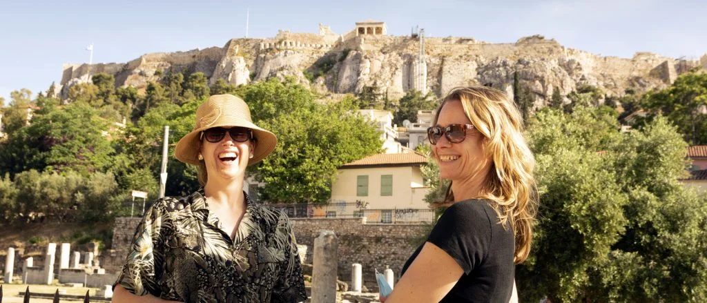 Alquiler de yate en Atenas: mujeres felices de vacaciones por ruinas griegas 