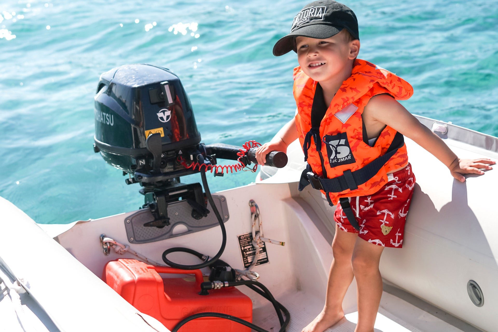 Child in zodiac boat in Italy