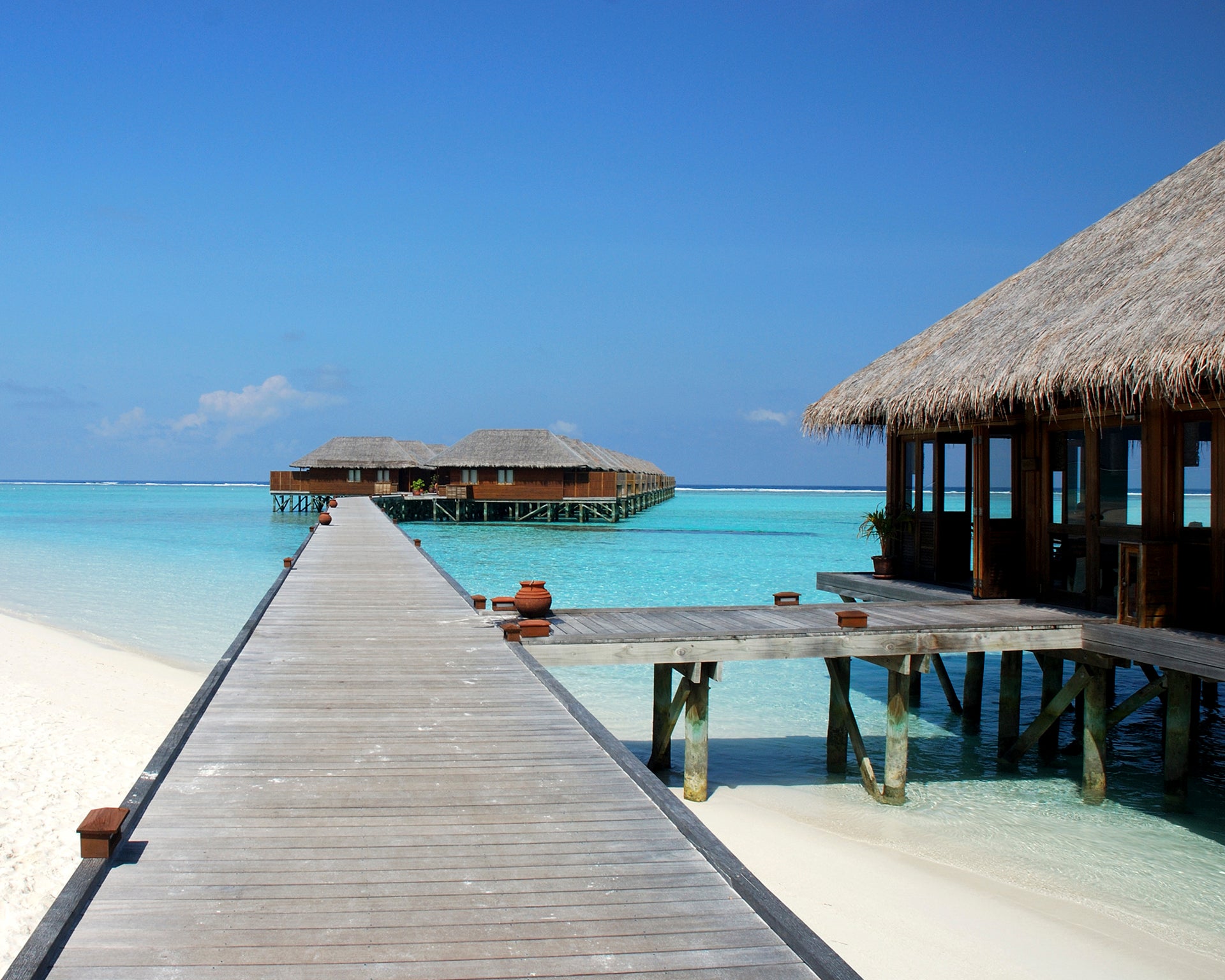 Maldives cabin by sea blue beach