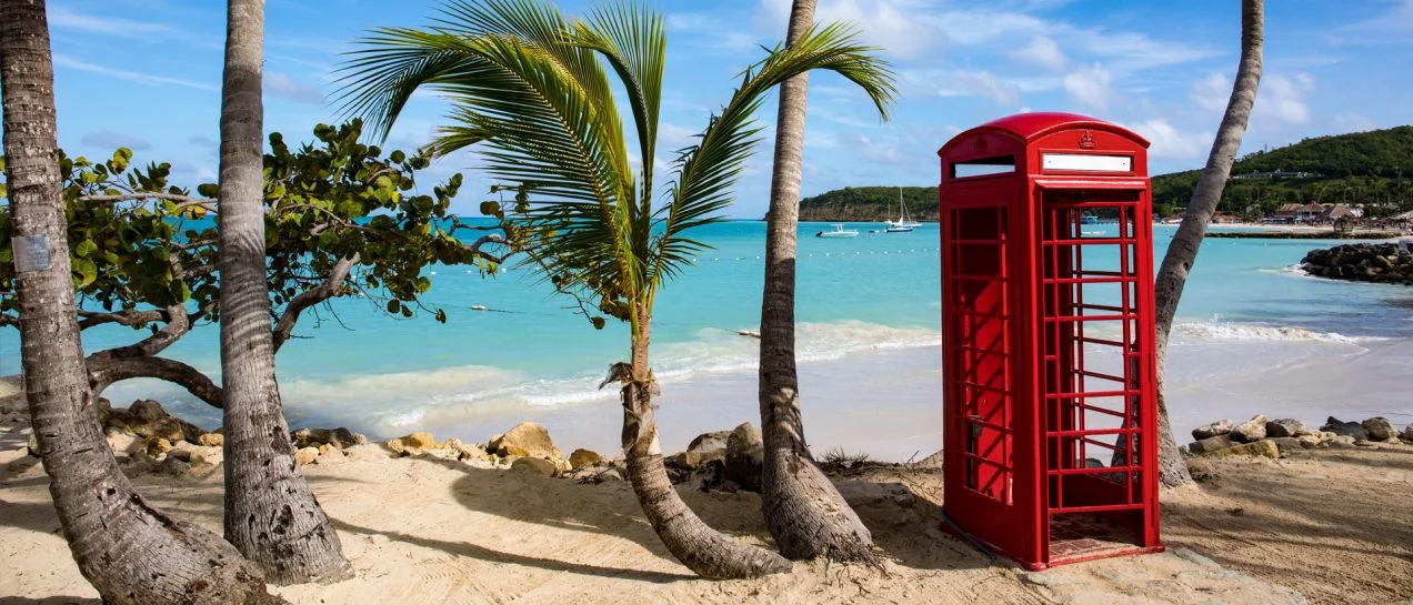 Antigua beach red telephone box palms