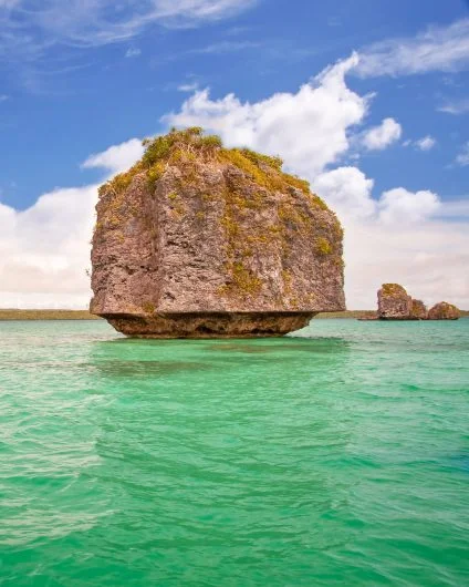 New Caledonia rock island on turquoise sea