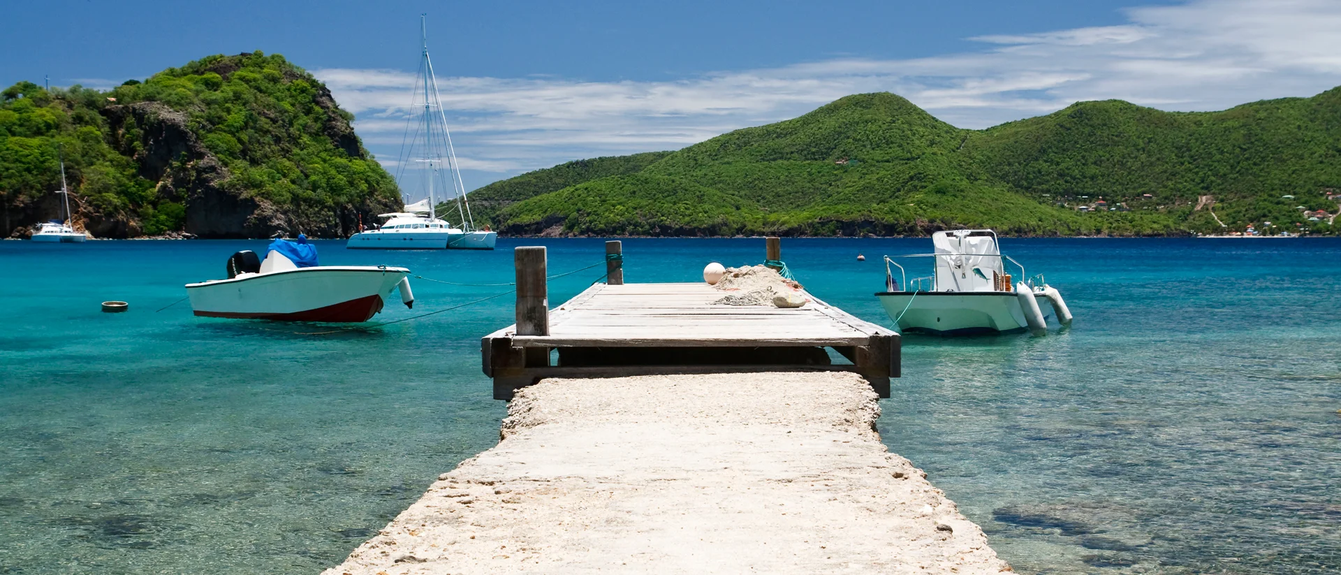 Caribbean pier and yacht and catamaran charter