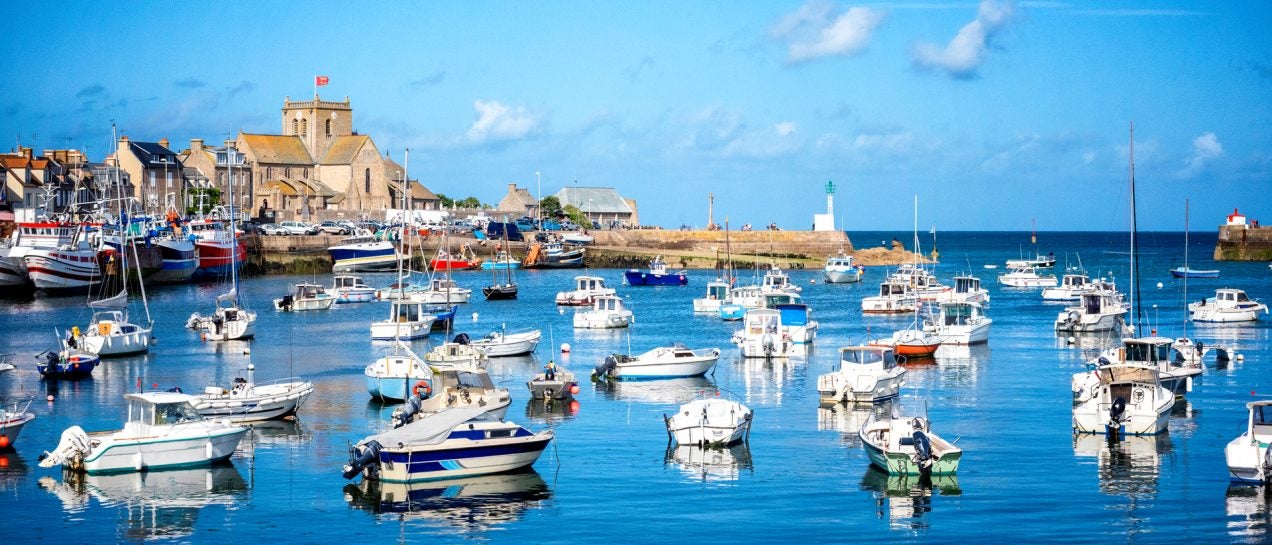 France village and bay with yachts and catamarans