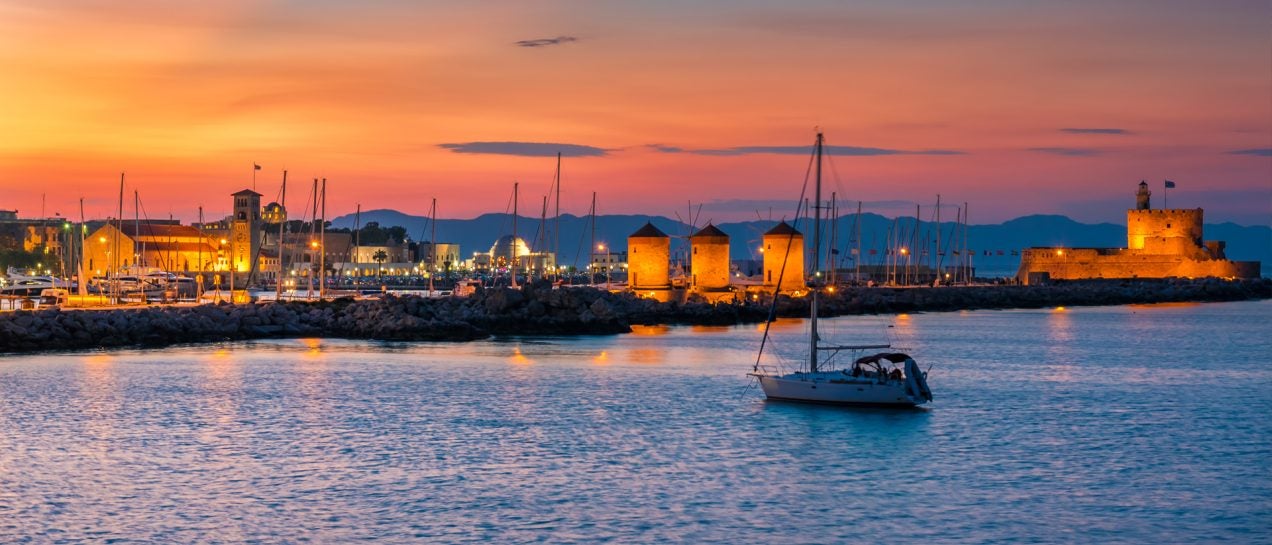 Greece coast windmills village and skippered yacht