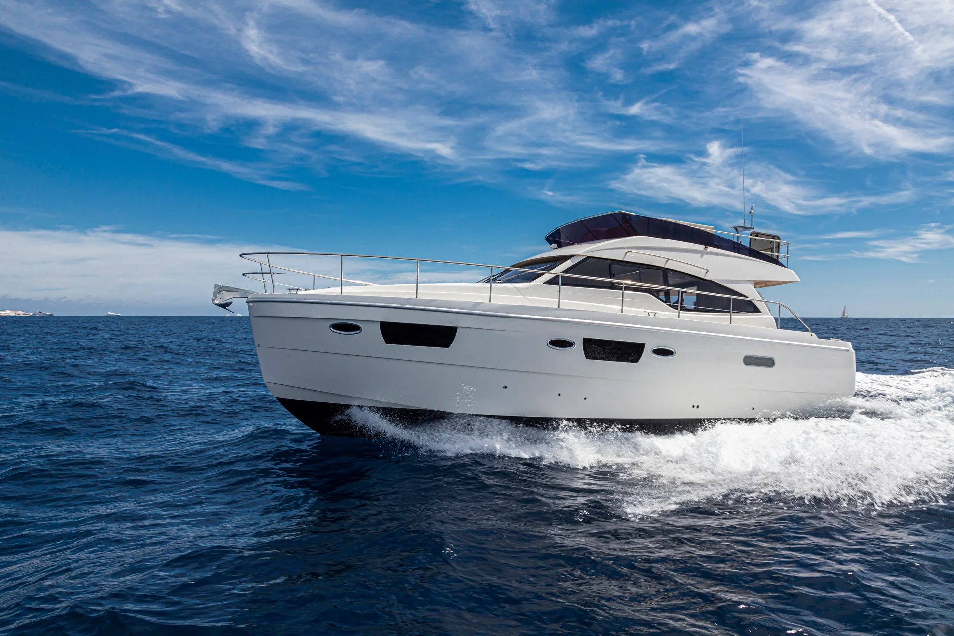 Powered catamaran yacht charter speeding in blue waters