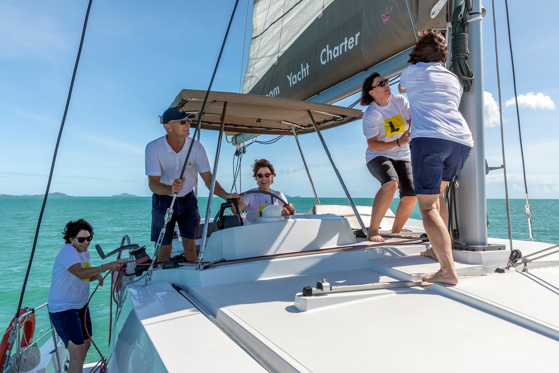 Group of friends sailing in a skippered yacht charter