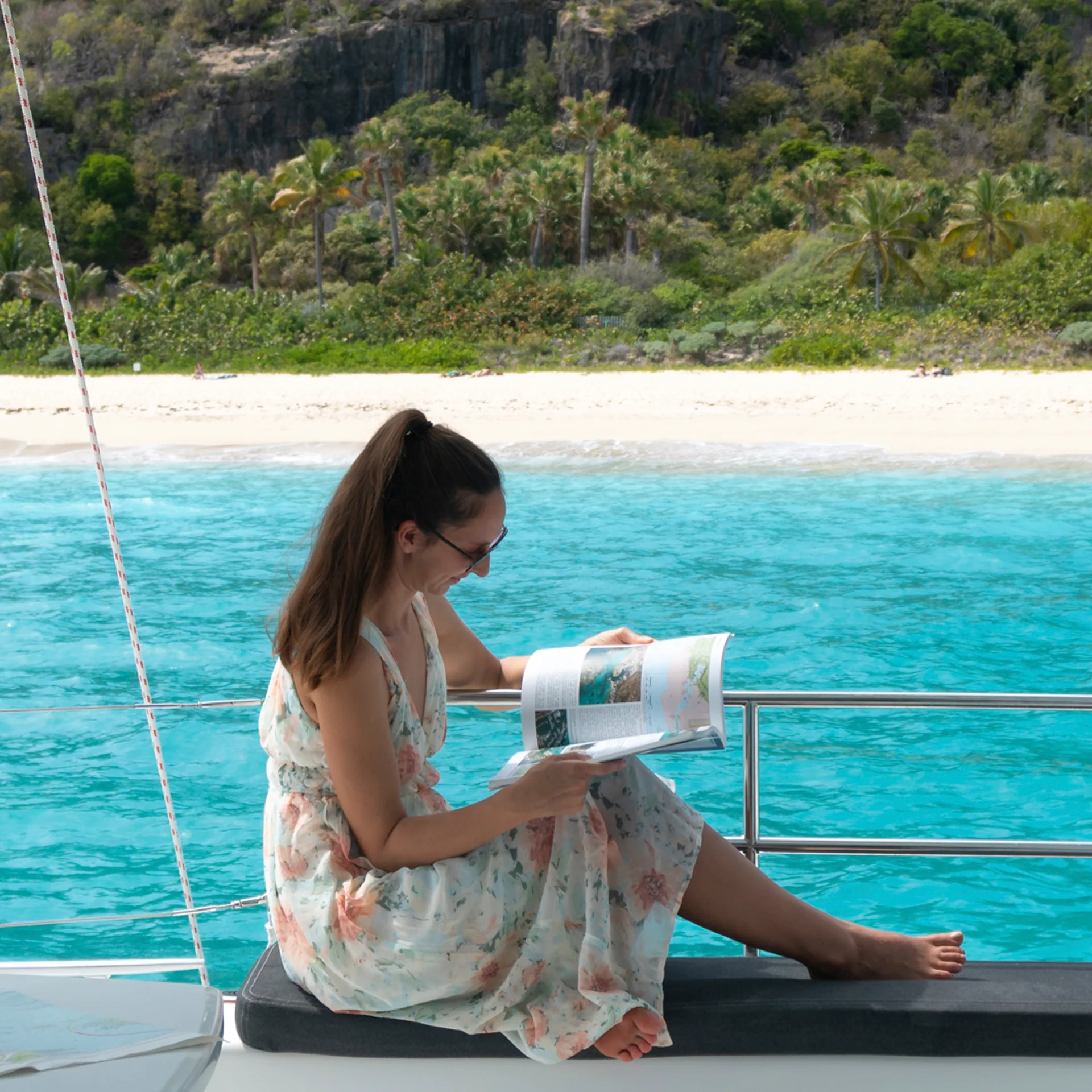 Woman reading in a yacht charter
