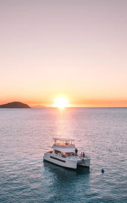 Power catamaran at sunset