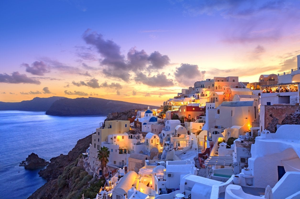 Beautiful sunset at greek village coastline and white houses