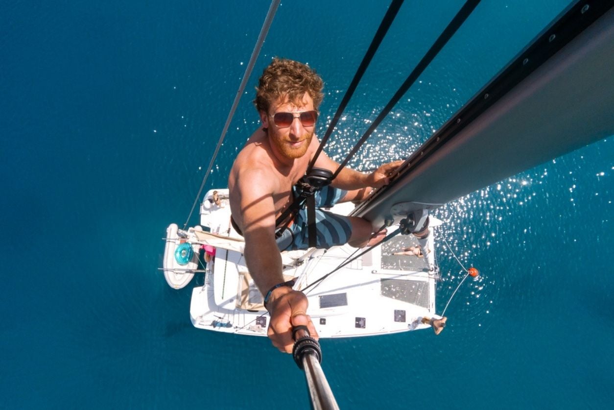 man at top of mast