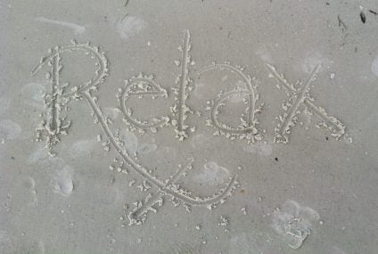 relax written in the sand
