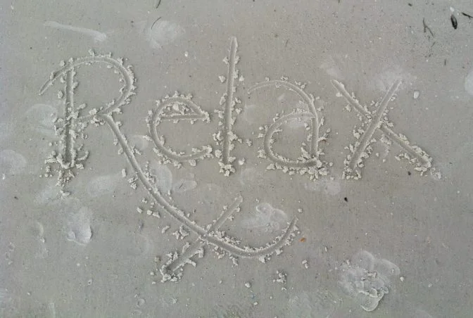 relax written in the sand