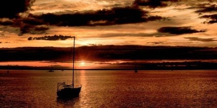 boat in the water at sunset with filter