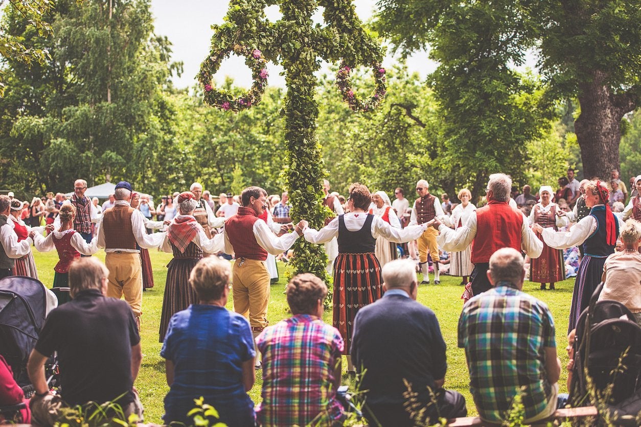 People dancing around Maypole at midsummer