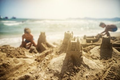 Brothers building sandcastles on the beach