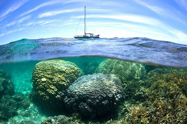 yacht floating above coral reefs in New Caledonia