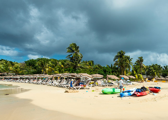 Enjoy a day of beach bars, sunbathing & water sports on Pinel Island