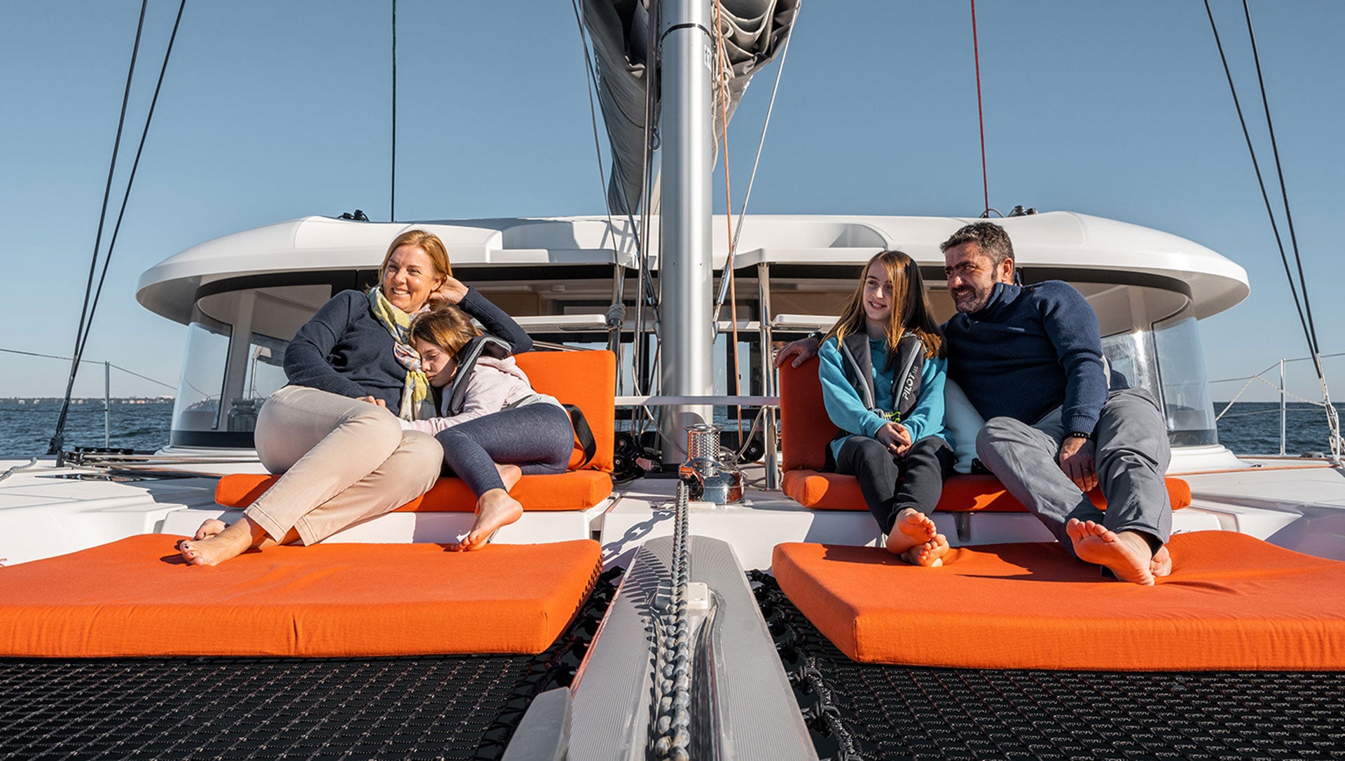 family lounging on an Excess 14 yacht