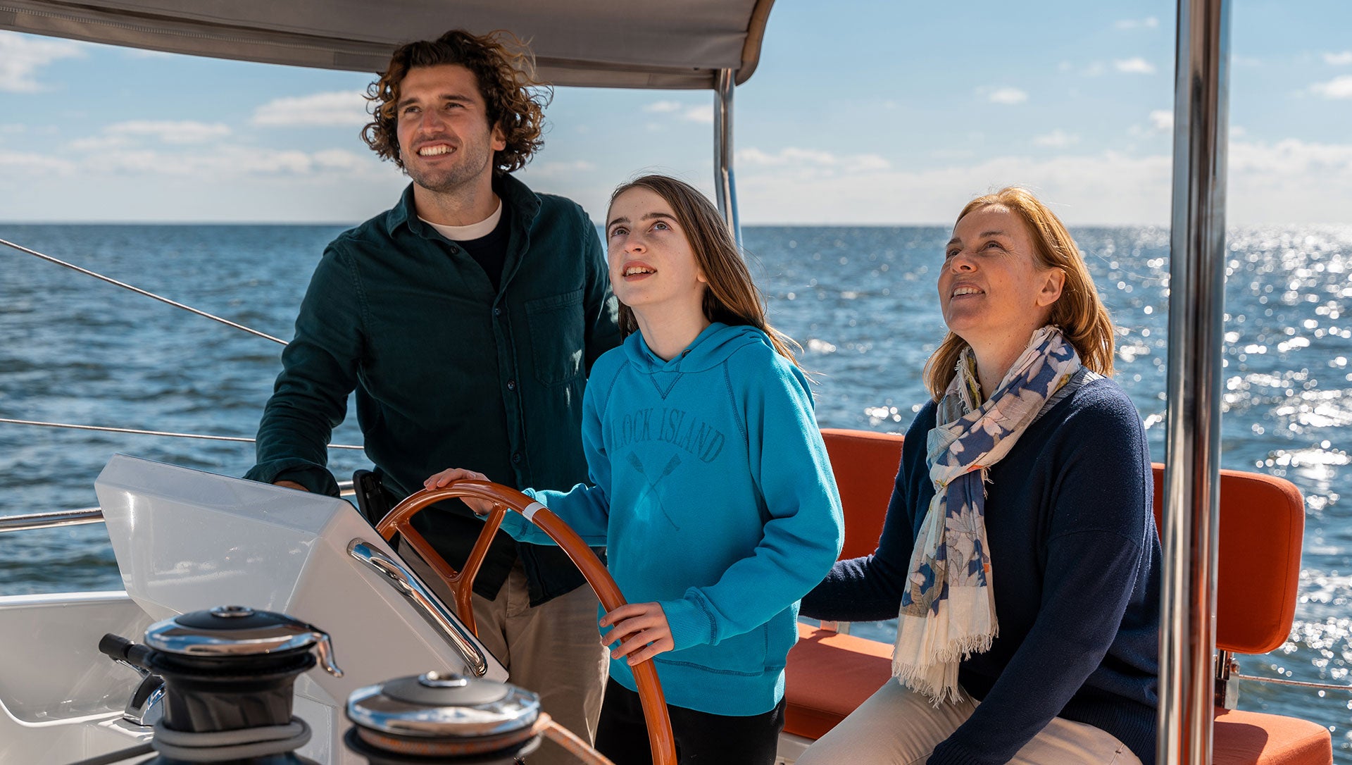 family at the helm of Excess 14 yacht in the Med