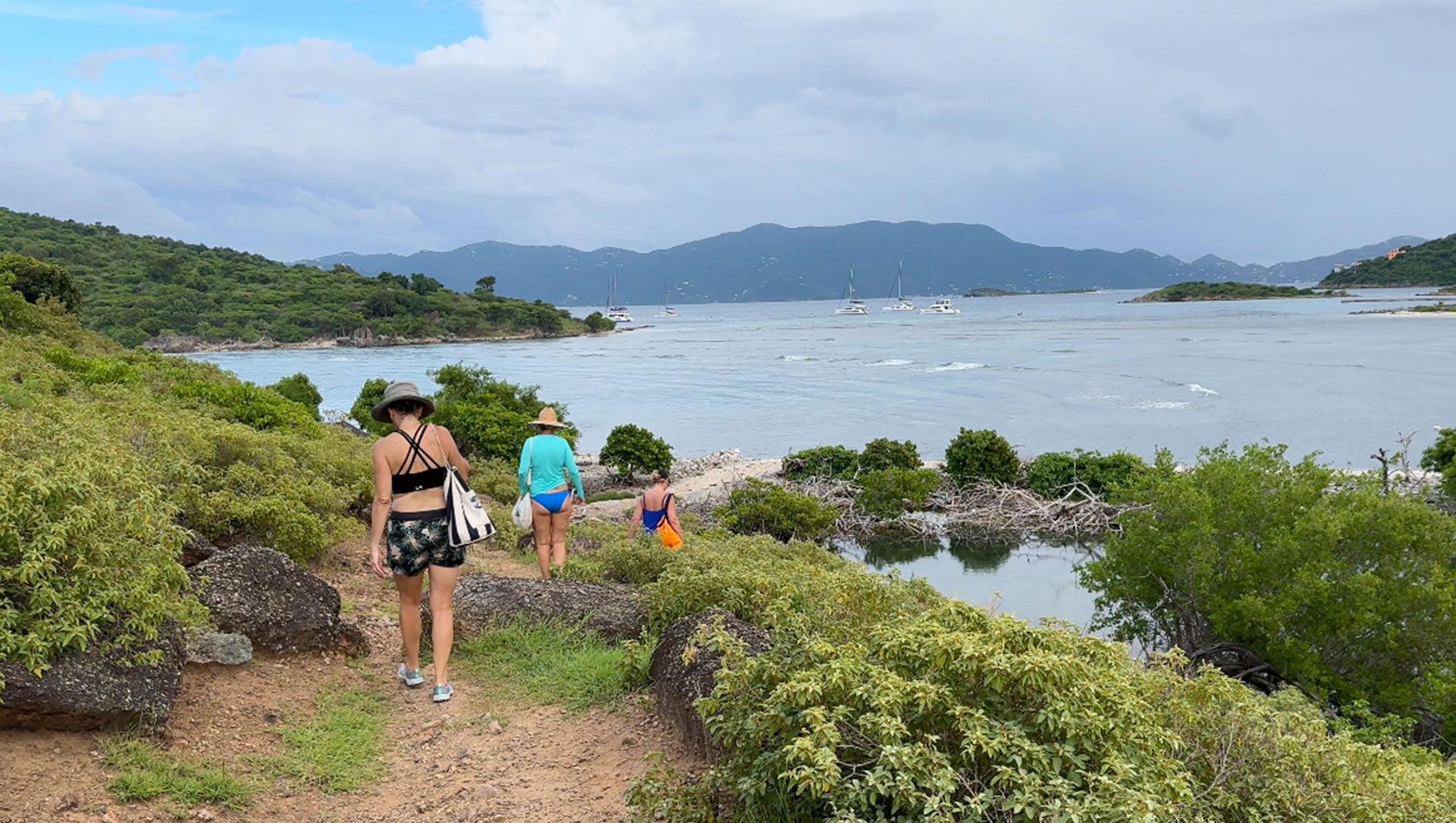 People hiking on the island of Jost Van Dyke while on yacht charter in the BVI
