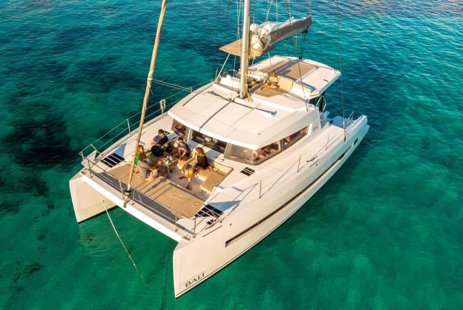 Sociial gathering in the forward cockpit of the sailing catamaran