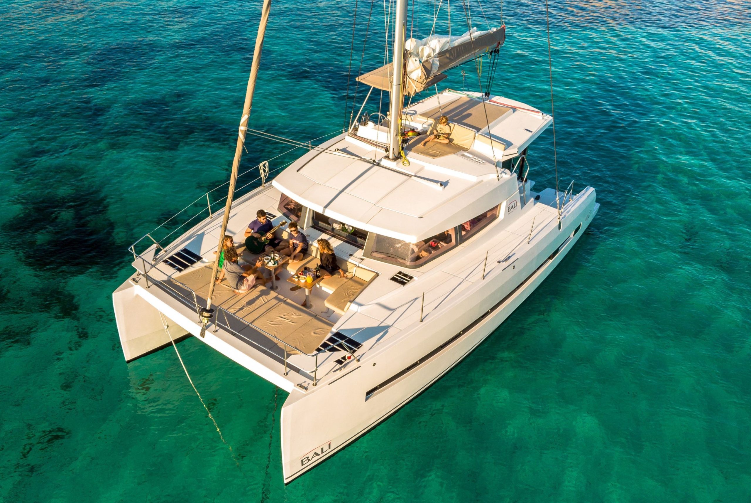 Sociial gathering in the forward cockpit of the sailing catamaran