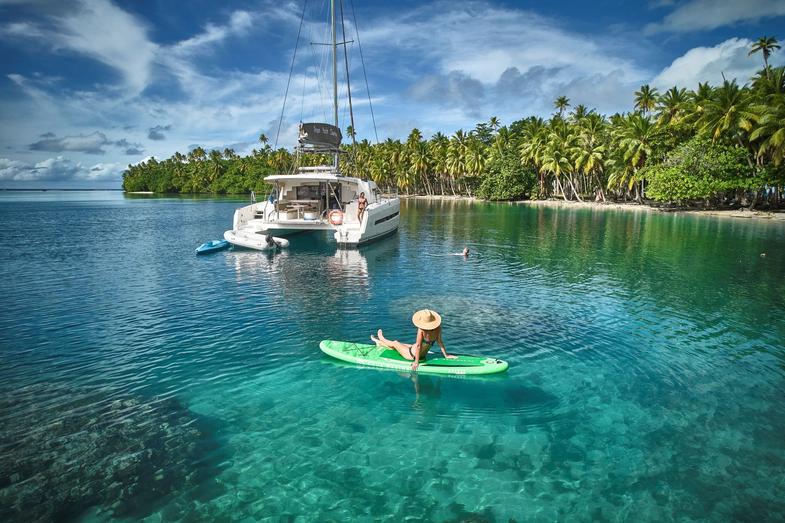 Paddleboarding at anchor in French Polynesia on crystal clear water
