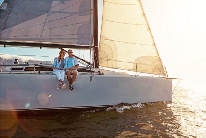 A couple on a sailing yacht at sunset